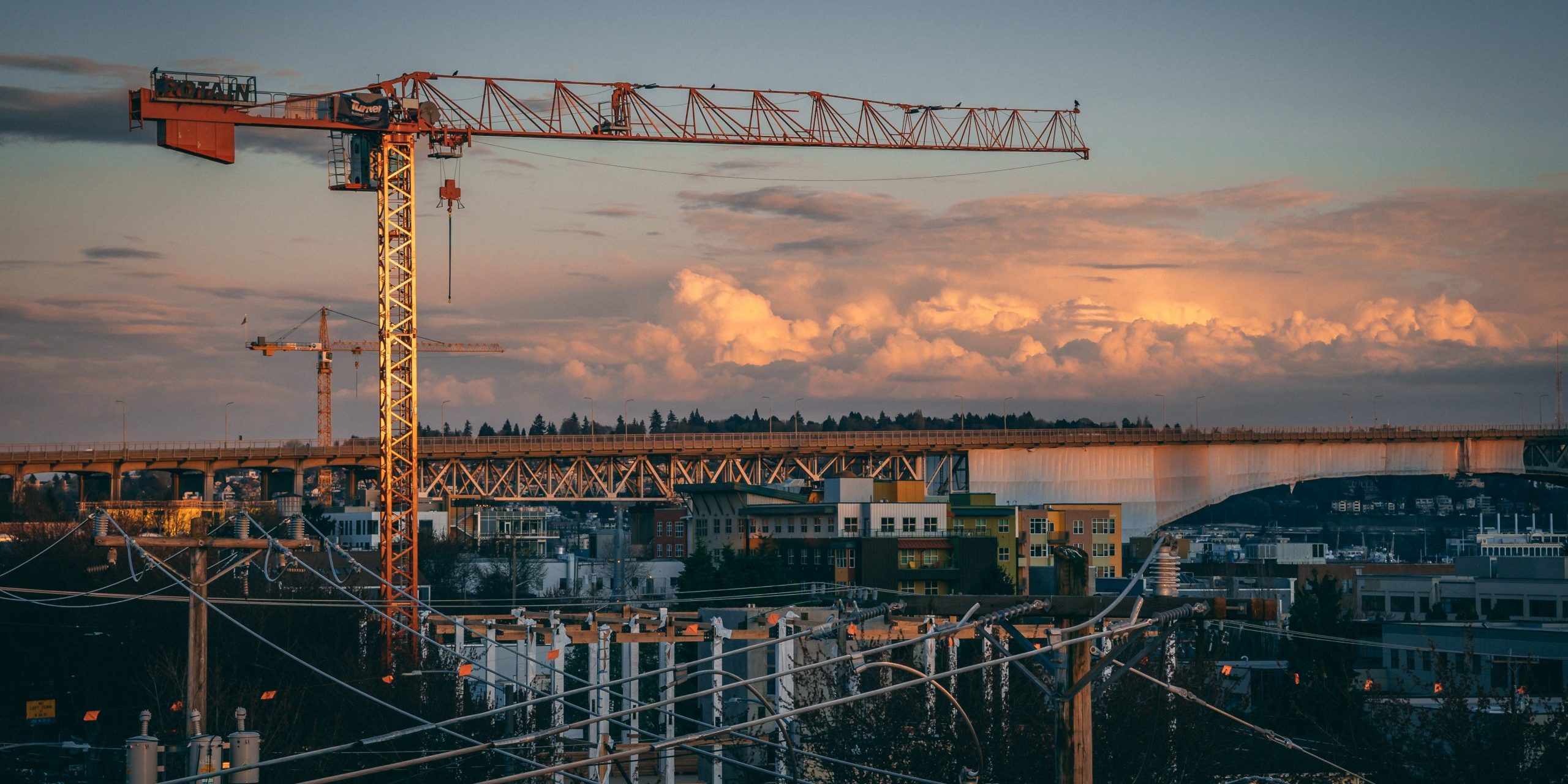 A beautiful view of a construction site in a city during sunset