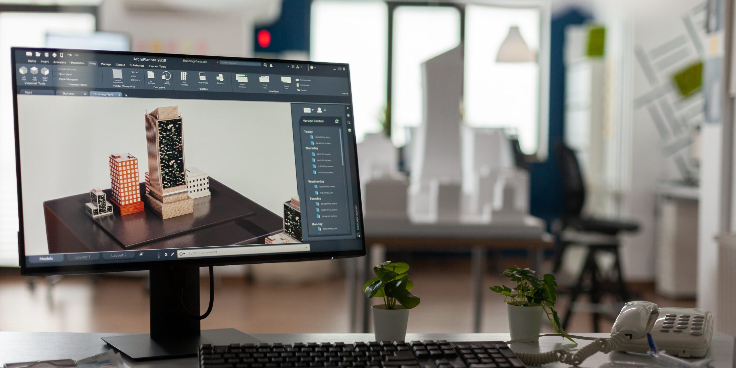 Computer display with 3d render software of architectural building complex in architect modern office. Desktop screen on desk showing urban planning architecture construction plans.