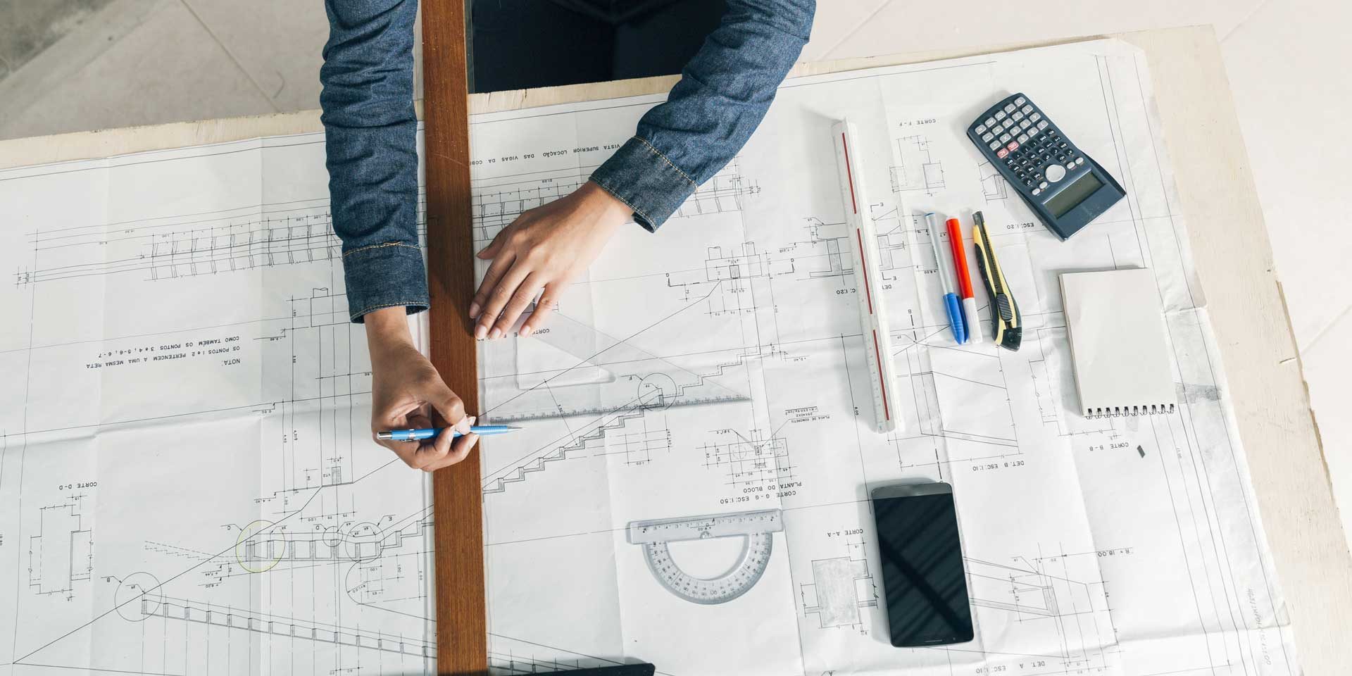 woman-working-with-big-ruler-pen-table